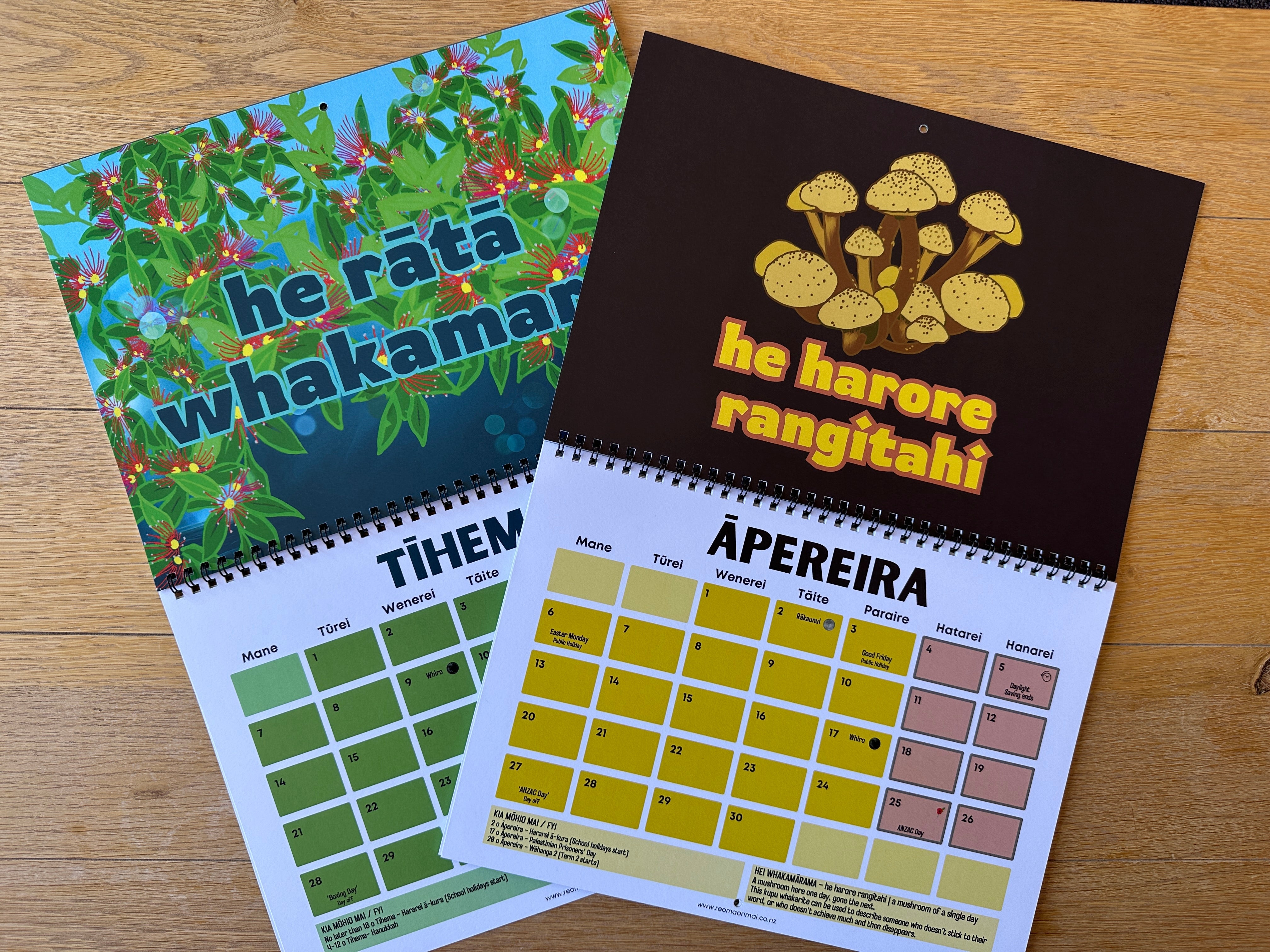 Two calendars with different designs on a wooden surface